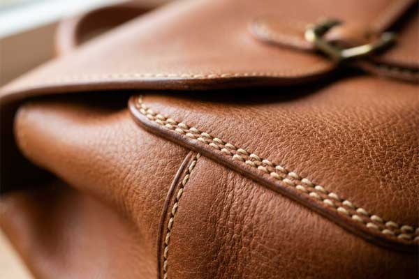 Italian handbag leather stitching close-up Italian leather handbag craftsmanship detail