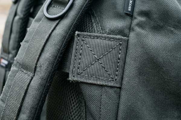 Industrial bartack stitching reinforcement backpack Close-up of box-and-X bartack stitching reinforcement at backpack shoulder strap anchor point