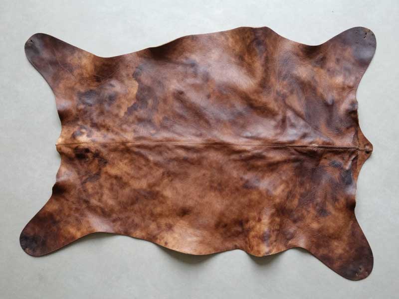 Natural grain patterns and characteristics of genuine leather for bag production genuine leather hide showing natural grain variation and surface characteristics